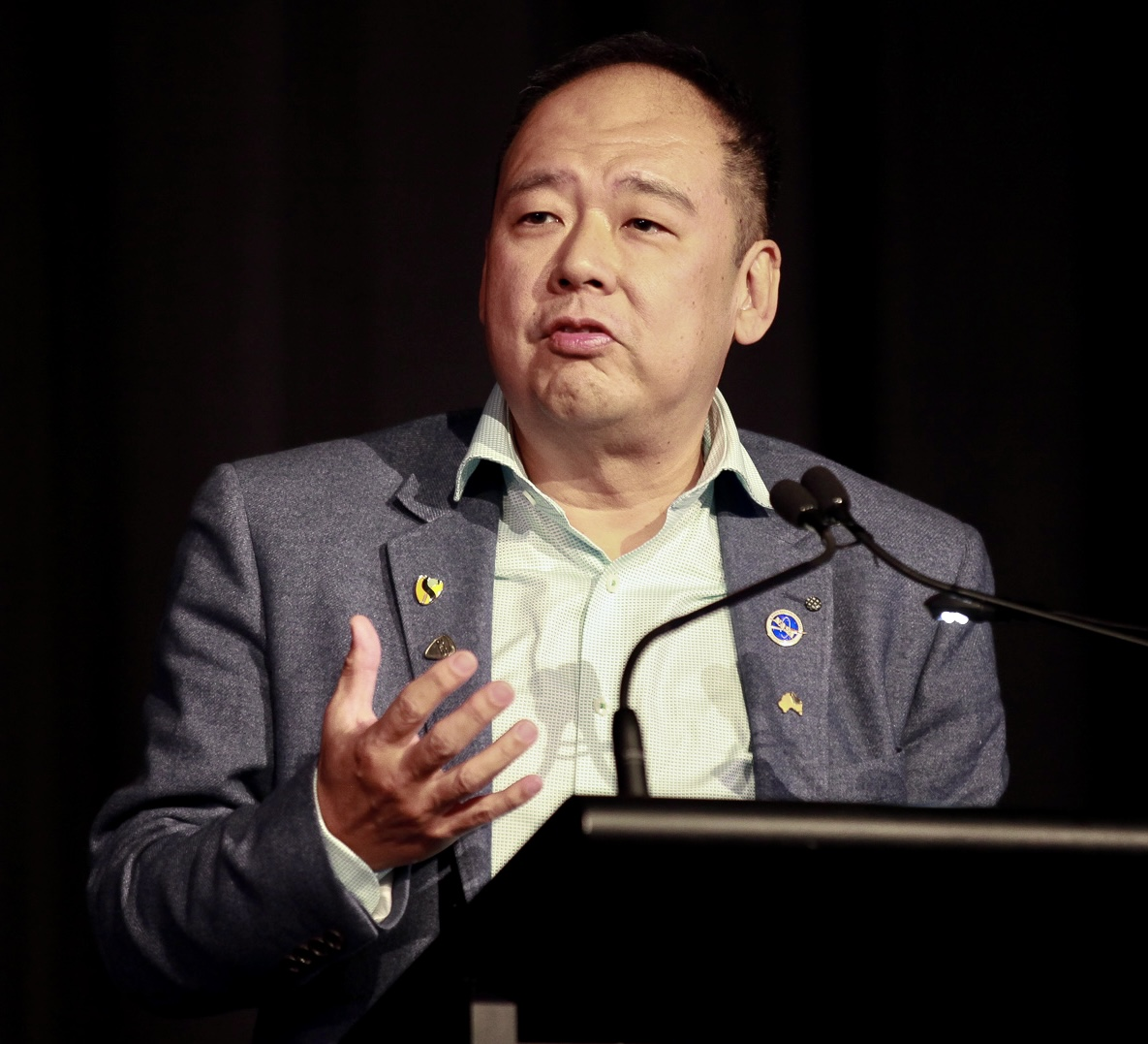 Dr. Clarence Tan speaking at a keynote event
